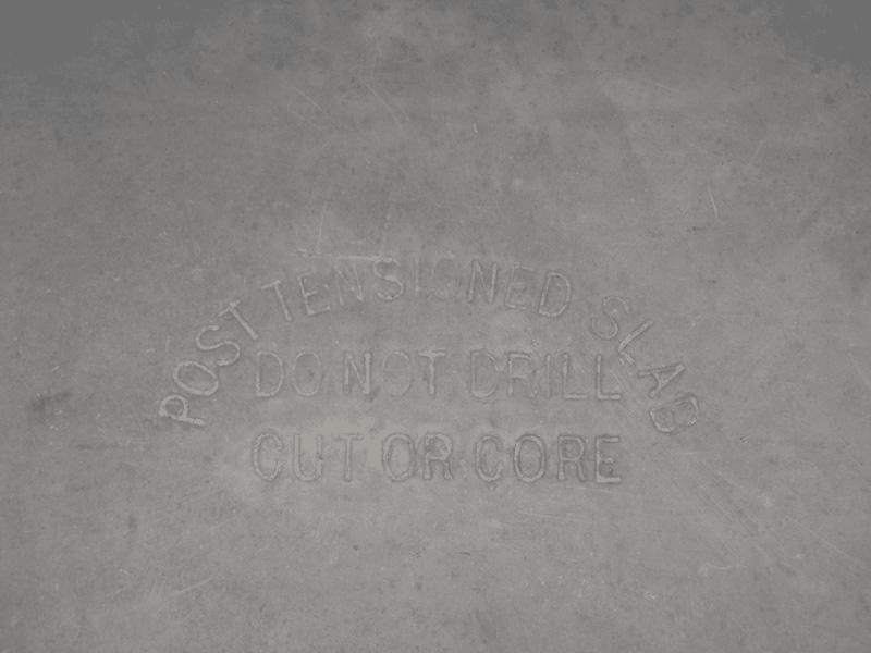 post-tensioned slab foundations are stamped with warnings -Post Tensioned Slab Do Not Drill Cut or Core